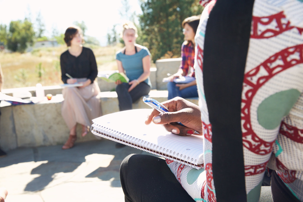 Students sitting outdoors chatting