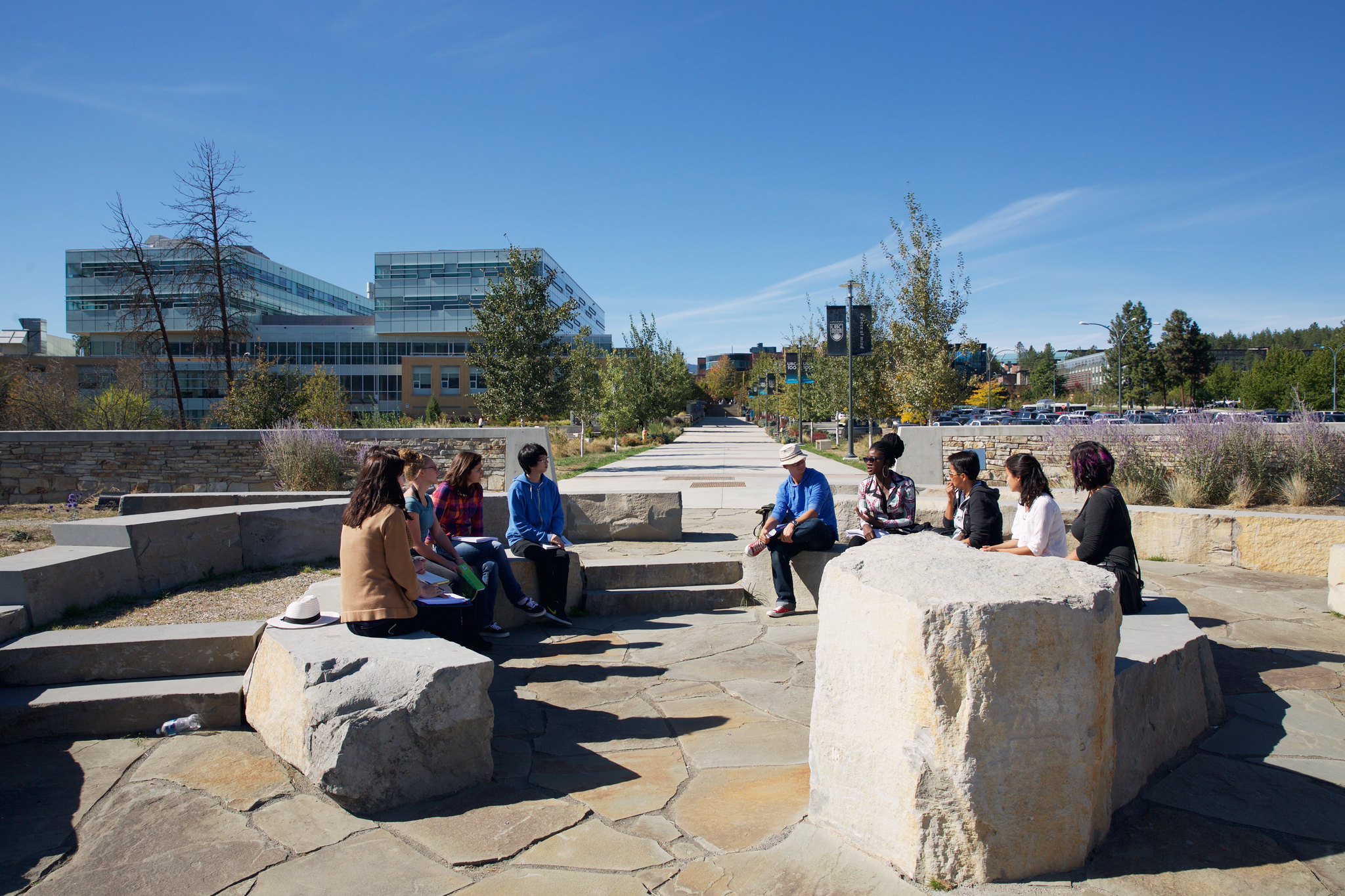 Students sitting outdoors on campus