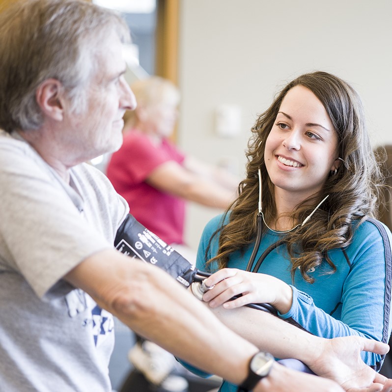Student taking participant pulse