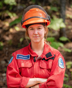 Madden Brewster in firefighting uniform and helmet with Research badge on her right upper chest.